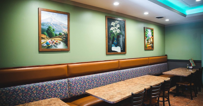 Seating area with paintings on the wall