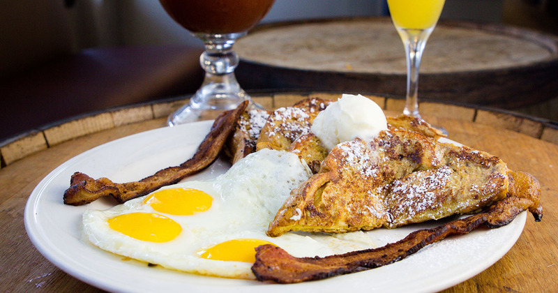 Eggs with bacon and french toast and two cocktails