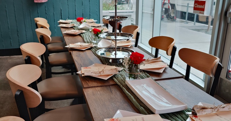 Interior, set dining tables and chairs by window