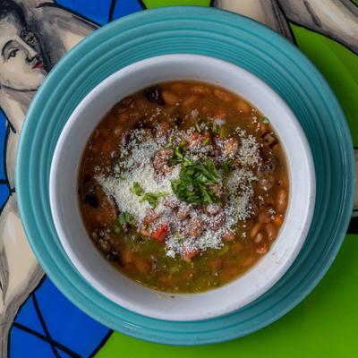 Mexican bean soup topped with cheese and cilantro.