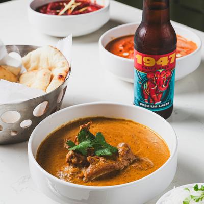 Butter chicken, naan bread, and beer.