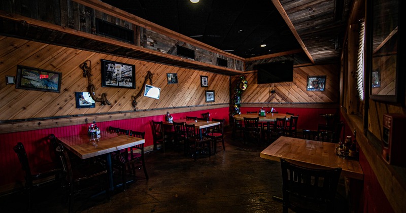 Interior, tables and chairs for guests, TV on the wall