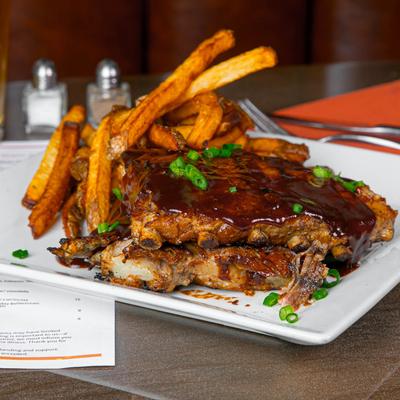 Braised pork rib topped with whiskey BBQ sauce and green onions, served with fries.