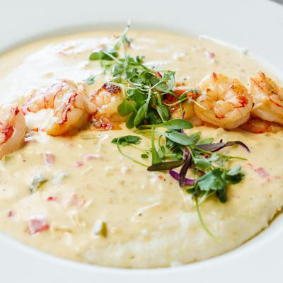 Creamy grits topped with shrimp and herbs.