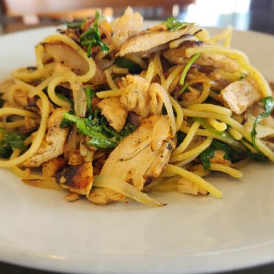 Pasta mixed with grilled chicken, greens, and caramelized onions.