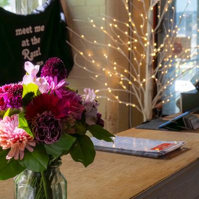 Colorful flower arrangement on a wooden counter.