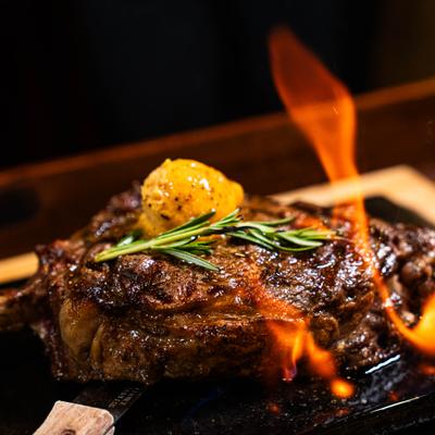 Flambéed Cowboy steak, closeup.