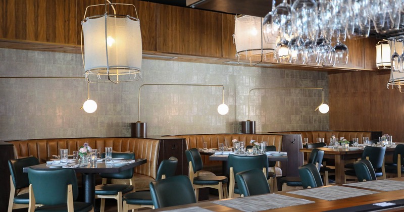 Interior, dining booths with tables set for guests