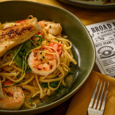 Shrimp Scampi served over linguini with toasted garlic bread on the side.