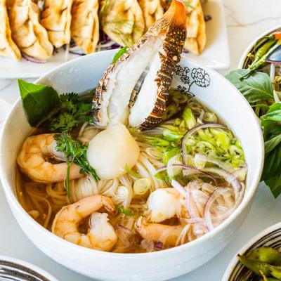 Lobster Pho with assortment of other dishes on the table
