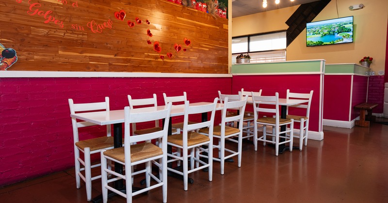 Interior, dining area with lined up white tables and chairs