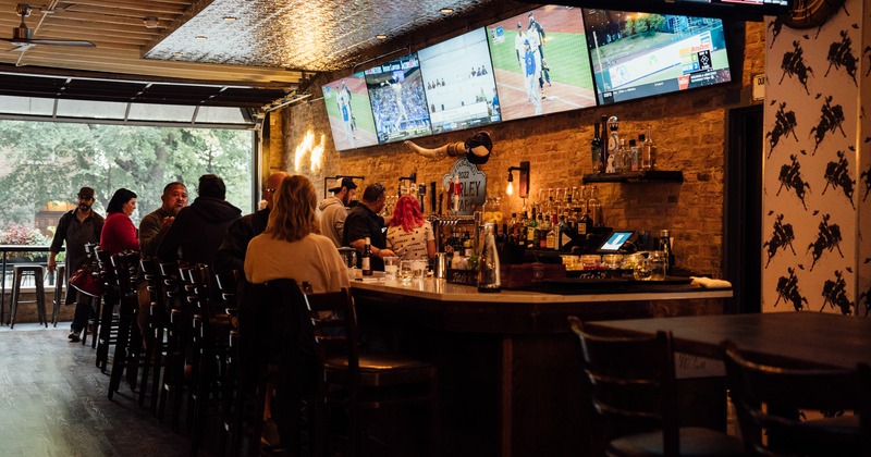 Interior, guests sitting at the bar