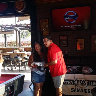 A guy in a red shirt and a girl posing for a photo