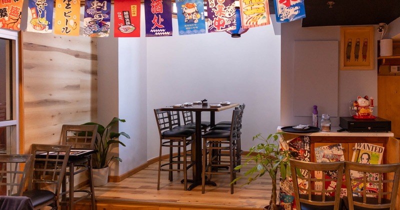 Interior, high seating area, wooden flooring, Japanese motifs flag pennant, plant decoration