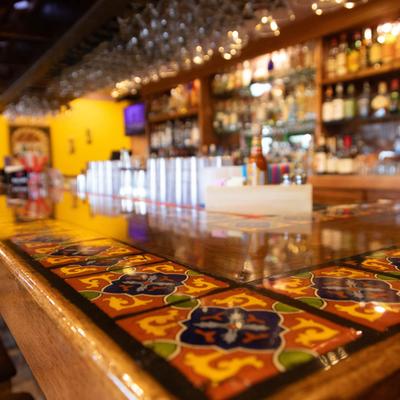 Interior, a close up of bar counter with colorful Mexican tiles.