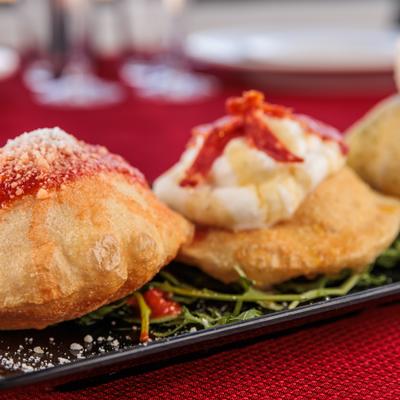 Small Montanara pizzas, with burrata and pesto, tomato and basil, and salami and cheese