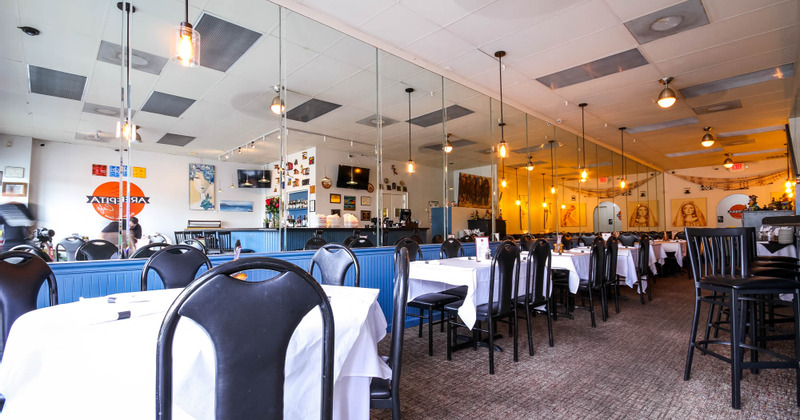 Interior, tables lined up by the wall with mirrors