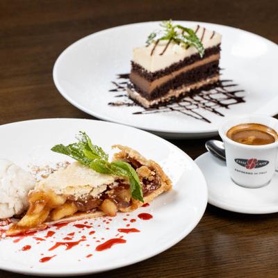 Apple strudel and mocha chocolate mousse on a table with a cup of espresso.