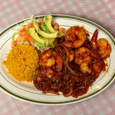 Spicy shrimp served with rice and avocado salad.