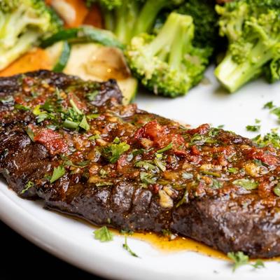 Skirt Steak with chimichurri sauce and vegetables.
