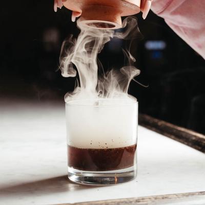 A cocktail, smoking.