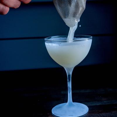 Bartender pouring a cocktail.