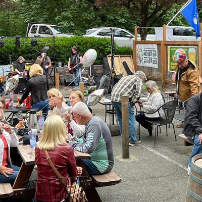 People sitting outside, socializing over drinks.