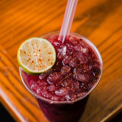 Blackberry Margarita garnished with a lime wheel.