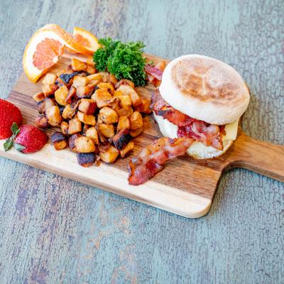 Egg, American, choice of bacon, sausage, or ham, on an English muffin.