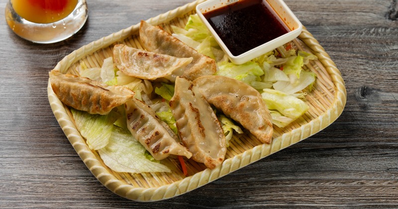 Gyoza dumplings served with a dipping sauce