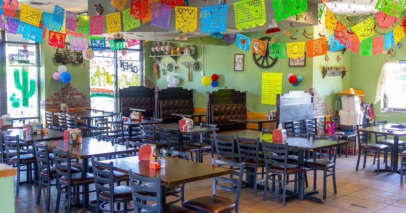 Interior, dining area, wooden top tables with chairs, seating booths in the back