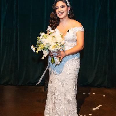 Interior, a jovial bride  holding a wedding bouquet
