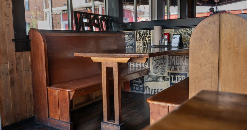 Booth seating, wooden booth bench and table close-up
