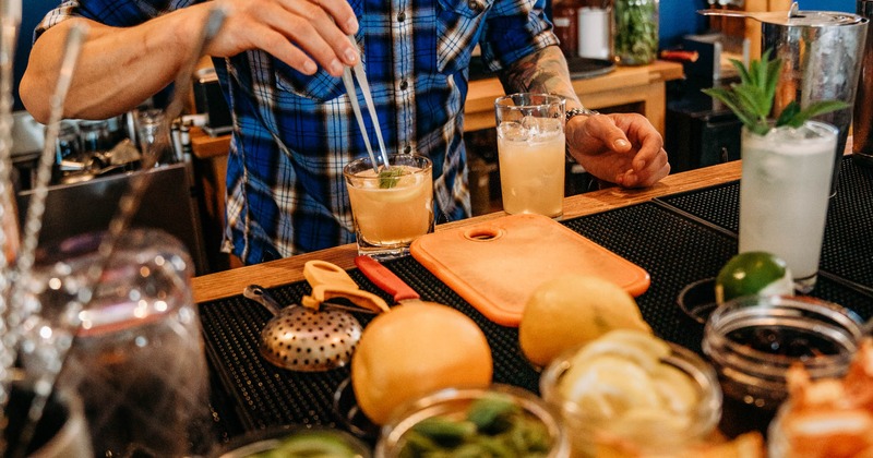 Bartender preparing cocktails on a bar counter