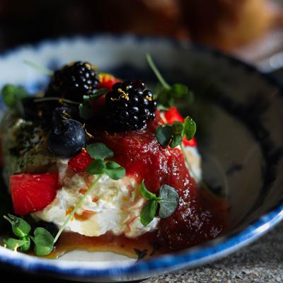 Fry bread topped with cream and mixed berries.