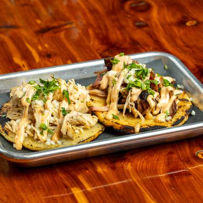 Loaded arepas, served on a tray.