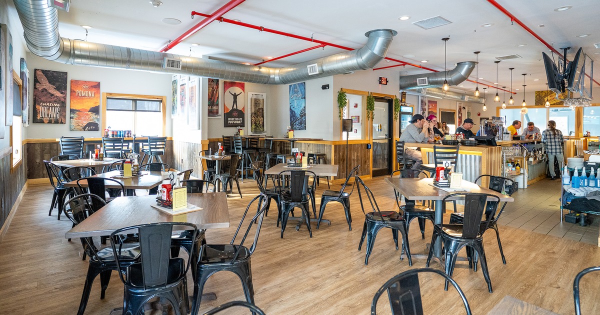 Spacious interior dining area and bar area with guests