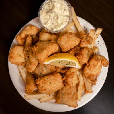 Fish and chips served with tartar sauce.