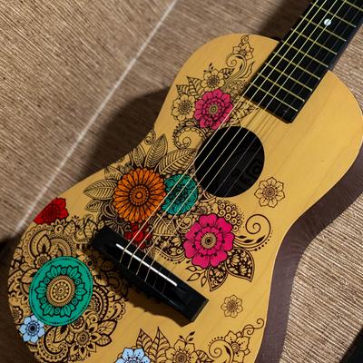 Ukulele decorated with floral illustrations.
