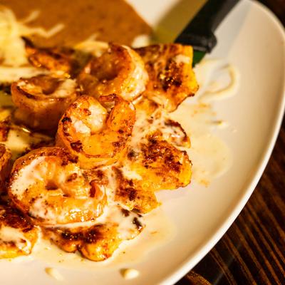 Chicken and shrimp, served on a plate, closeup.