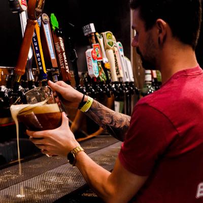 Bartender pouring beer from the tap.