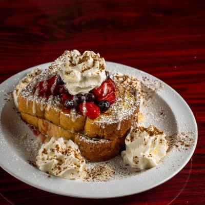 Stuffed French Toast topped with berry compote, whipped cream and powdered sugar.