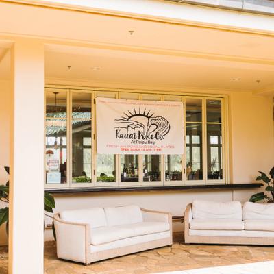 Kauai Poke Co patio seating with a storefront sign and outdoor couches.