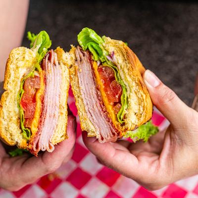 Italian sub sandwich in hands.