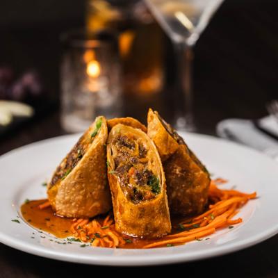 Filet Mignon Spring Rolls on a bed of shreded carrots.