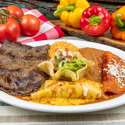 Steak with rice, beans, guacamole, and enchilada.