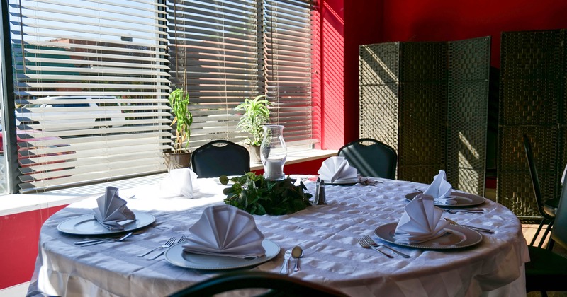 Interior, table set for guests in dining area