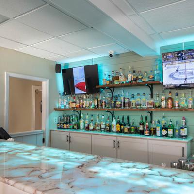 Marble bar counter, various liquor bottles on the shelf.