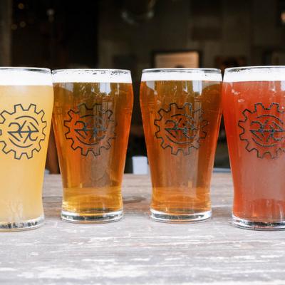 Four colorful beers lined up across a table.