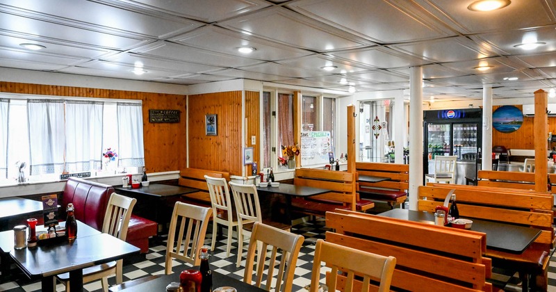 Diner area, angle view, tables and chairs, wooden boots